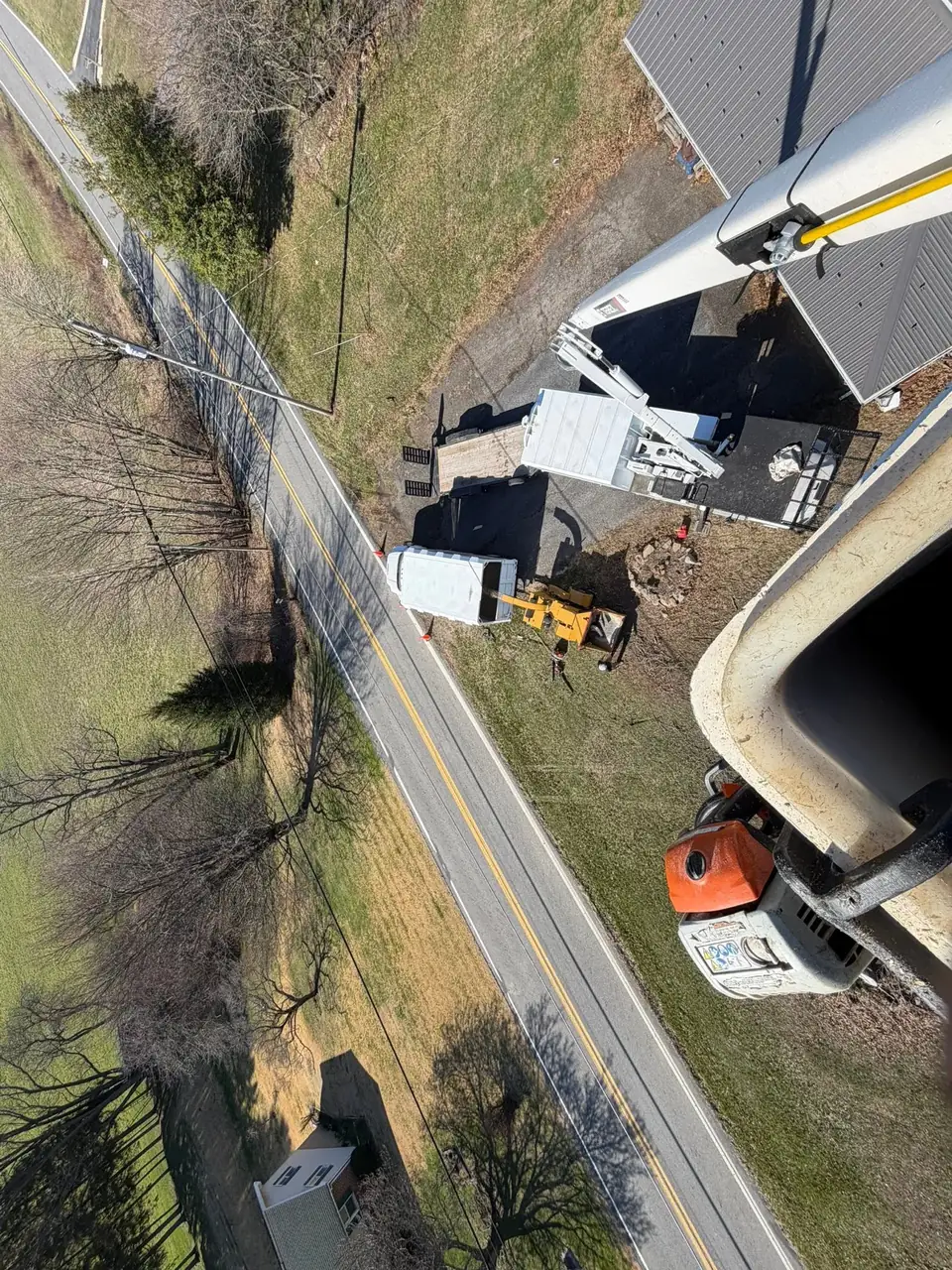 View from the bucket over the crew and chipper below